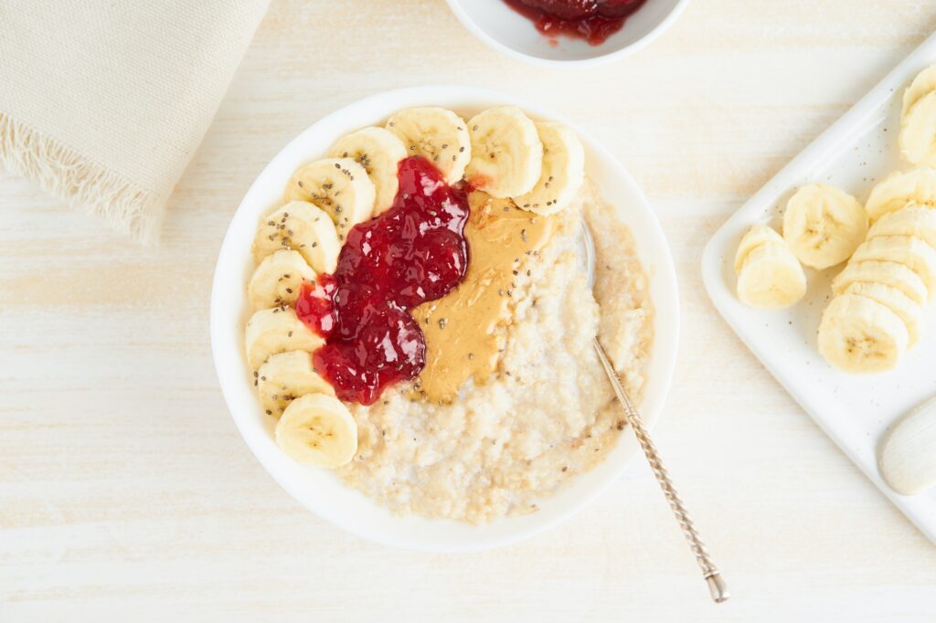 Oatmeal porridge, healthy vegan diet breakfast with strawberry jam